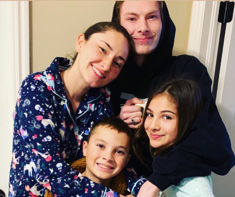 A photo of Jen's children snuggled up and smiling. 